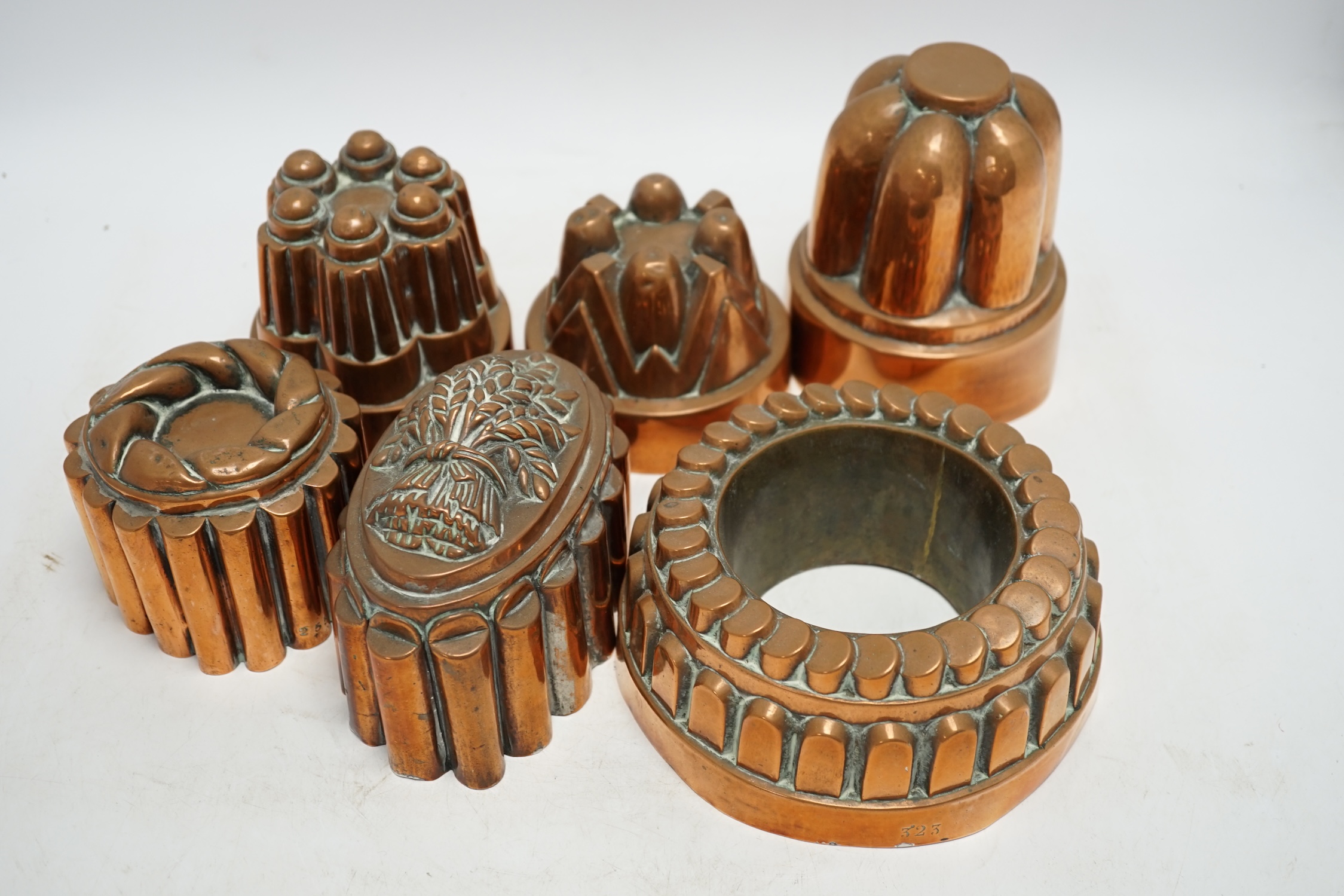 Six Victorian copper jelly moulds, tallest 14.5cm high. Condition - good